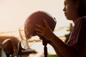 person putting on a helmet, getting ready to ride their motorcycle in New Jersey