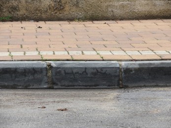 steeply sloped edge of a sidewalk jersey city