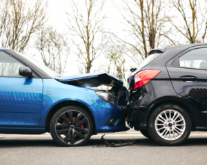 two damaged cars after a car accident on the side of the road